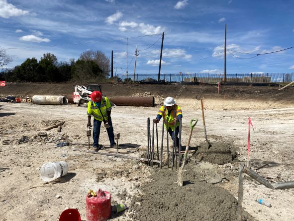 Oak Hill Parkway crew member conducts a concrete and rebar quality check on bridge foundation at US 290 near Old Bee Caves Road. These foundations will be followed by the construction of concrete columns that will support the future US 290 westbound front